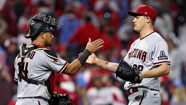 Paul Sewald celebrates a win in NLCS Game 6 with Gabriel Moreno